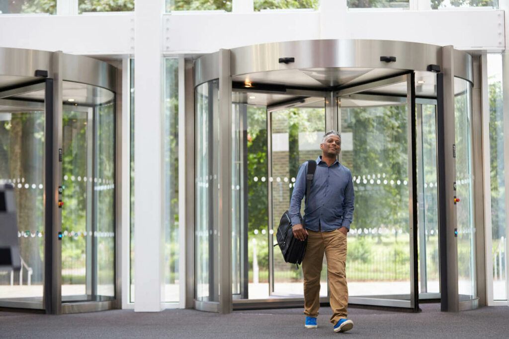 Man entering the foyer of a modern office building