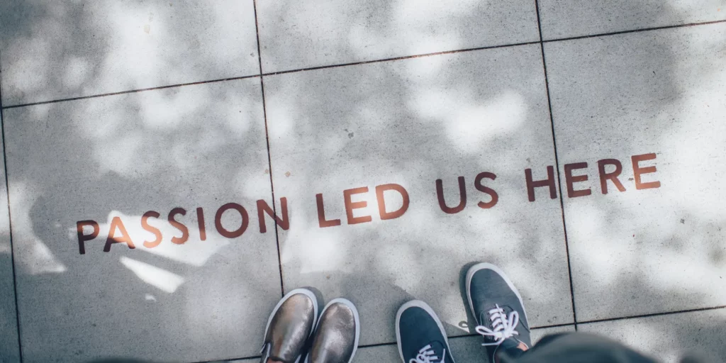 Message on the sidewalk that reads "Passion led us here."